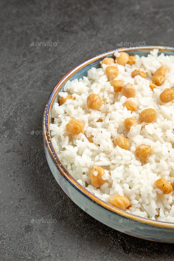 Half shot of quick and easy peas and rice meal for dinner on dark table